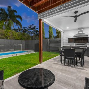 An Elegant Outdoor Entertaining Area with a Pool Fenced off Using a Frameless Glass Balustrade